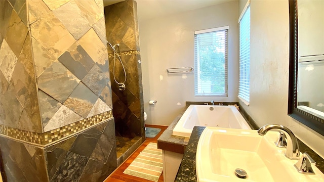 full bathroom featuring toilet, wood-type flooring, sink, and independent shower and bath