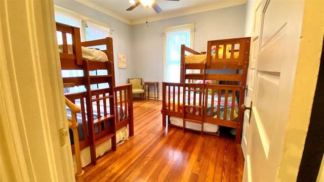 bedroom featuring hardwood / wood-style flooring and crown molding