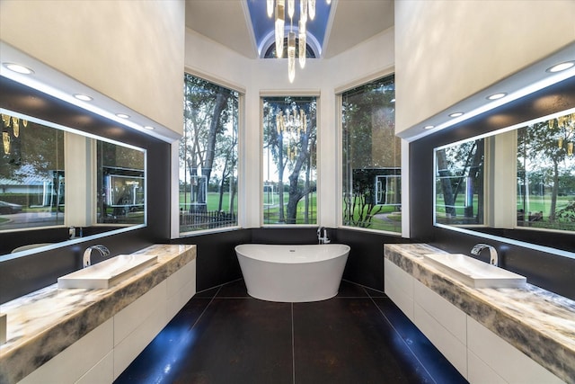 bathroom featuring recessed lighting, a soaking tub, two vanities, a sink, and tile patterned flooring