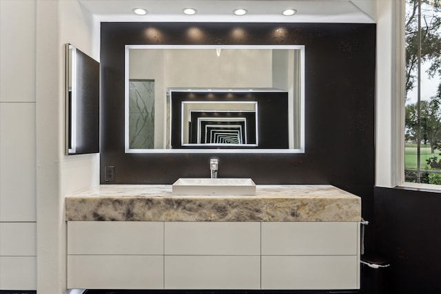 interior space with vanity and recessed lighting