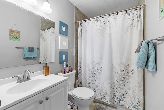 bathroom with curtained shower, toilet, a textured ceiling, and vanity