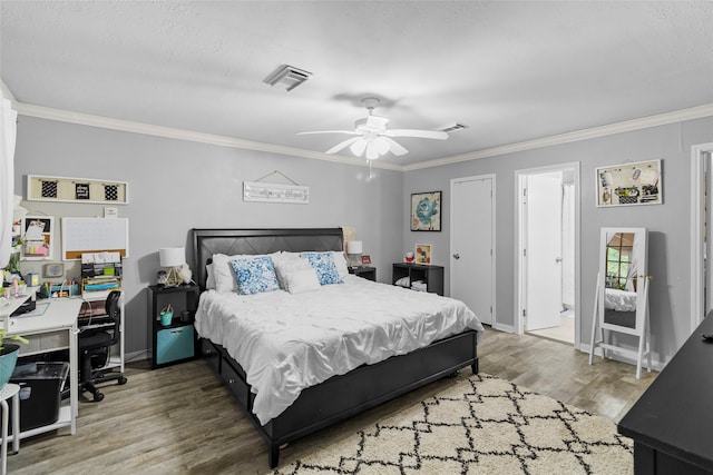 bedroom with hardwood / wood-style floors, crown molding, a textured ceiling, ceiling fan, and ensuite bathroom