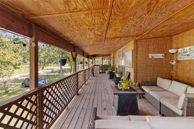 wooden terrace with an outdoor hangout area