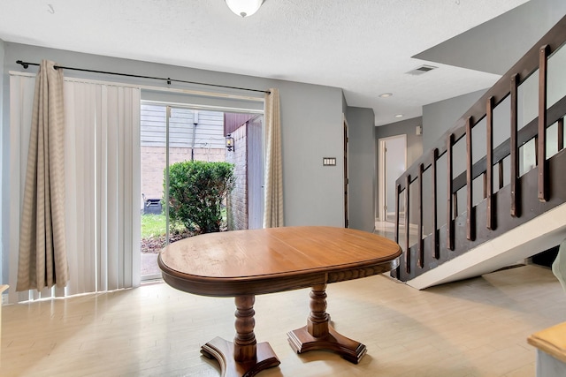 foyer entrance featuring a textured ceiling and hardwood / wood-style flooring