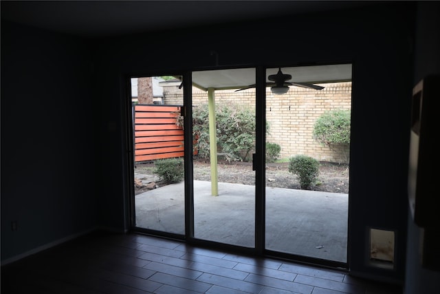 doorway featuring wood-type flooring and ceiling fan