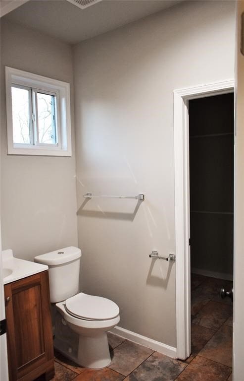 bathroom with toilet and vanity