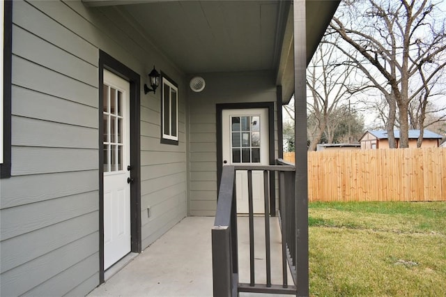 view of exterior entry featuring a yard