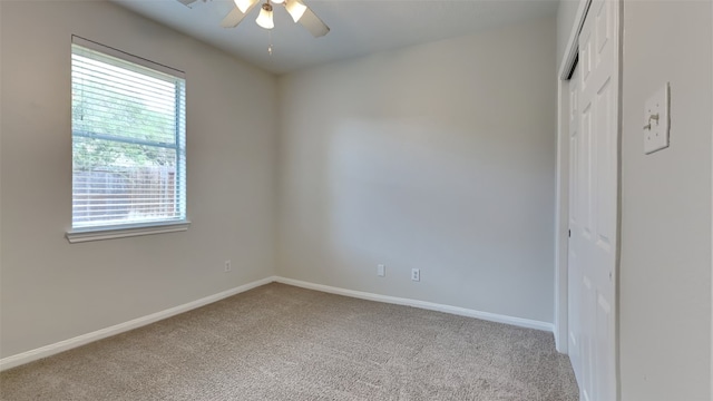 unfurnished bedroom with multiple windows, ceiling fan, and light colored carpet