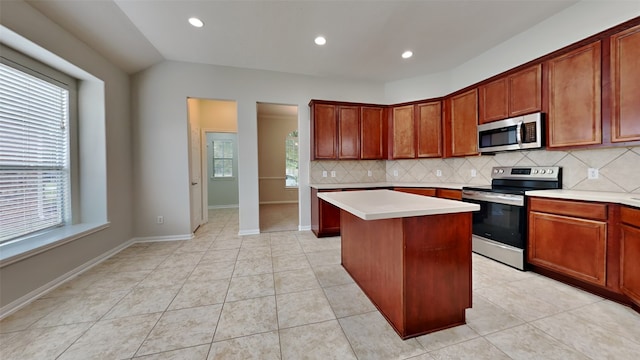 kitchen featuring backsplash, appliances with stainless steel finishes, plenty of natural light, and a kitchen island