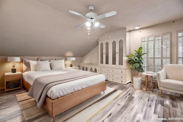 bedroom featuring lofted ceiling, ceiling fan, and hardwood / wood-style flooring