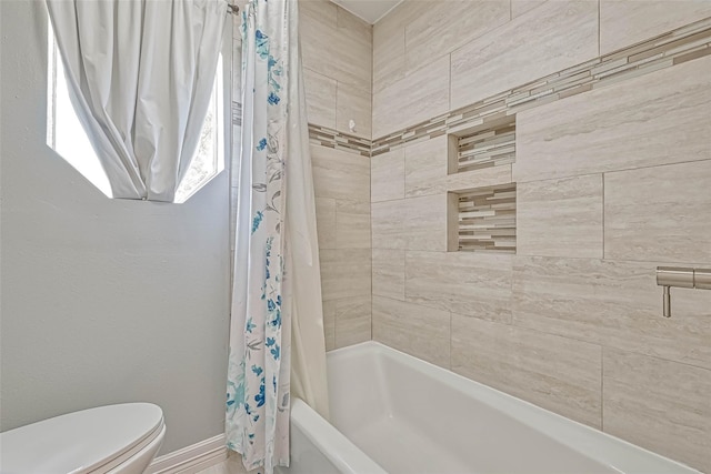 bathroom featuring toilet and shower / tub combo