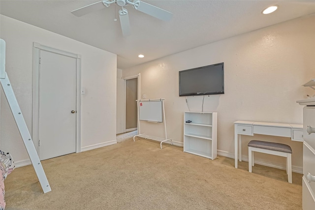 office featuring ceiling fan and light colored carpet