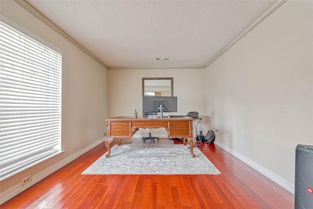 office space with hardwood / wood-style flooring, crown molding, and a textured ceiling