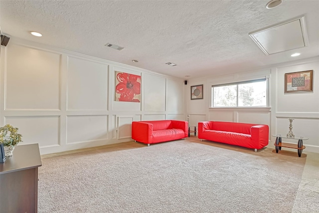 interior space with light carpet and a textured ceiling