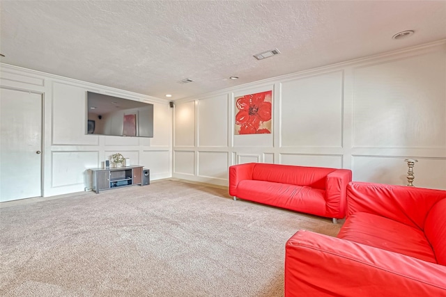 living room with ornamental molding, a textured ceiling, and carpet