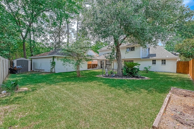 back of house featuring a storage shed and a yard