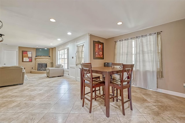 dining area with a brick fireplace