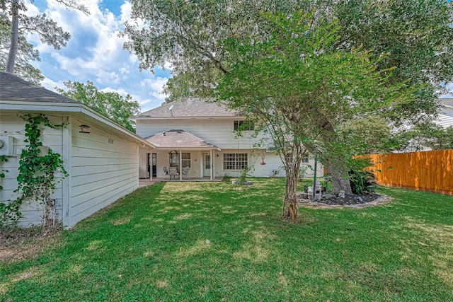 rear view of house with a yard