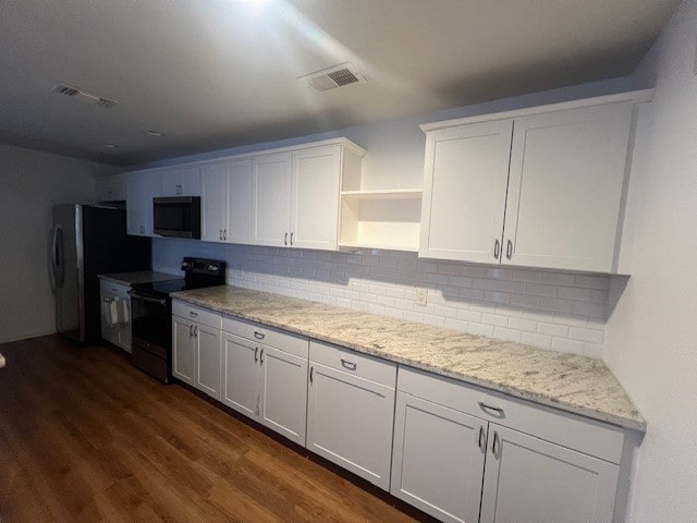 kitchen with light stone counters, white cabinets, tasteful backsplash, dark hardwood / wood-style floors, and black range with electric cooktop