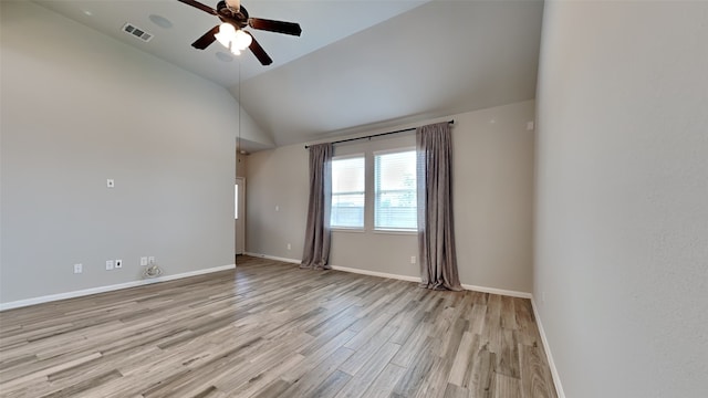 empty room with lofted ceiling, ceiling fan, and light hardwood / wood-style floors