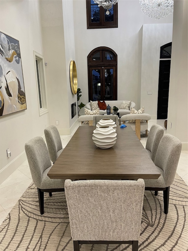 dining room featuring light tile patterned floors and a notable chandelier