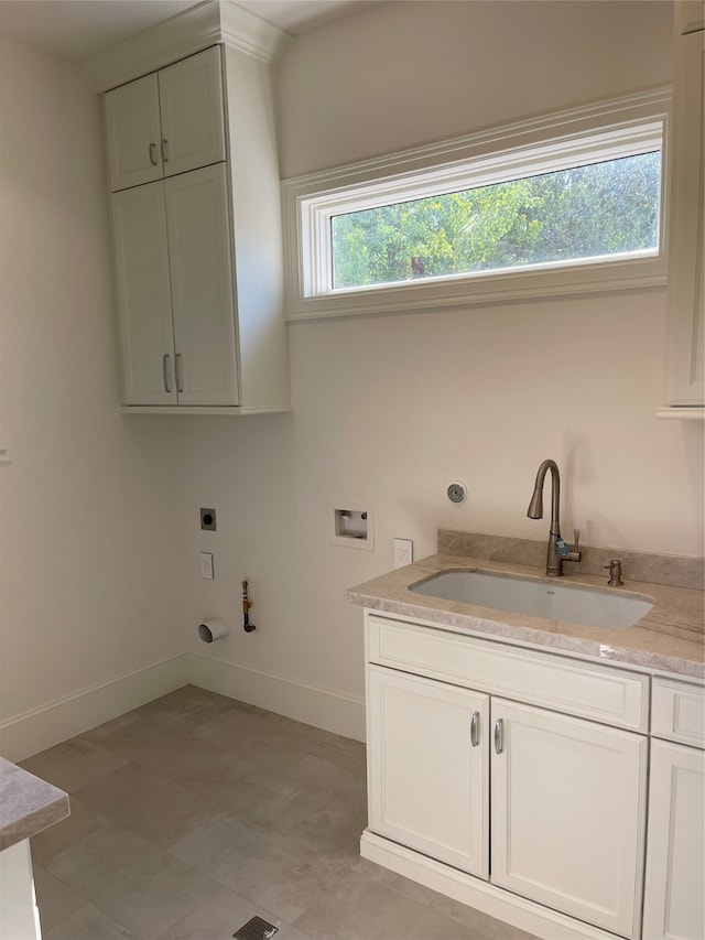 laundry room with cabinets, hookup for a washing machine, gas dryer hookup, sink, and hookup for an electric dryer