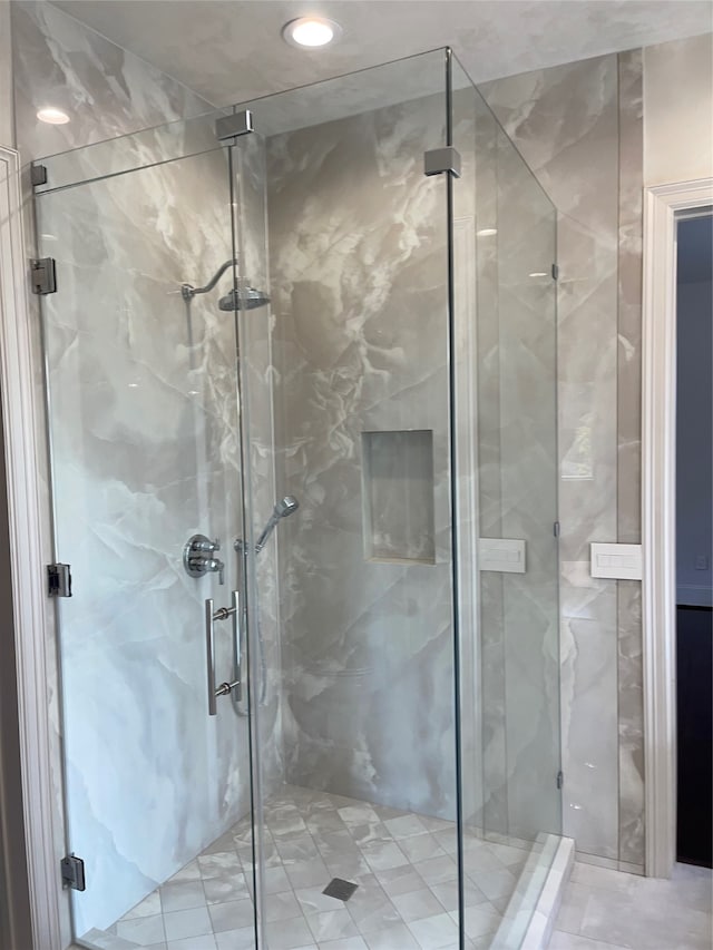 bathroom featuring a shower with shower door