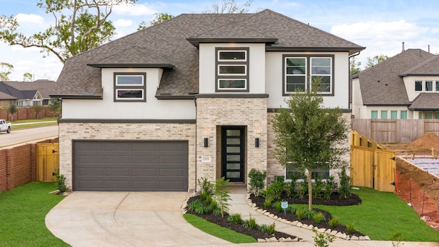 view of front of home with a front lawn and a garage