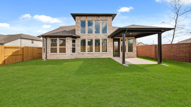 back of property featuring a patio area and a yard