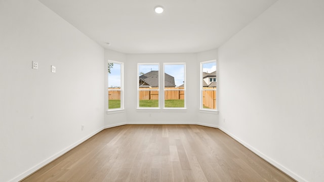 unfurnished room with light hardwood / wood-style flooring