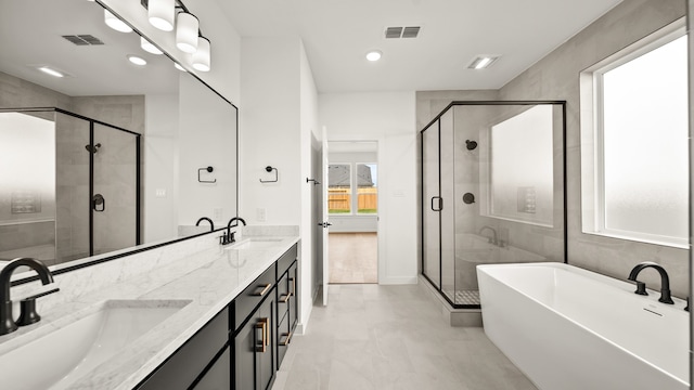 bathroom featuring vanity and shower with separate bathtub