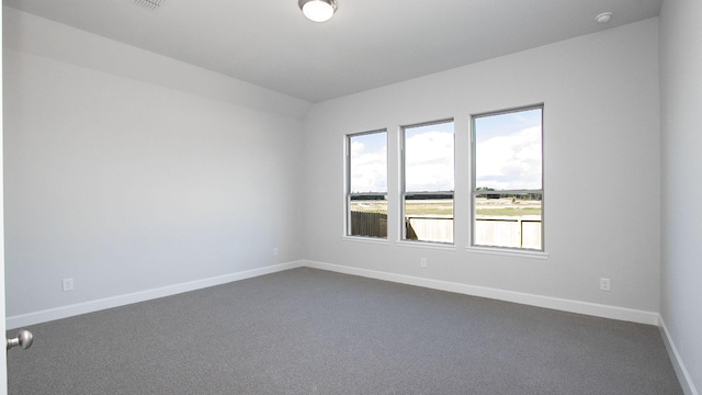 unfurnished room with dark carpet