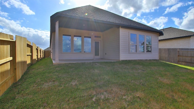 back of property featuring a yard and a patio area