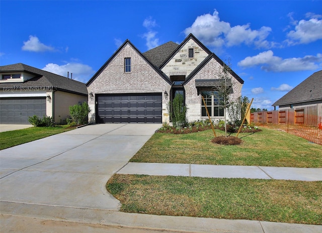 view of front of home with a front yard and a garage