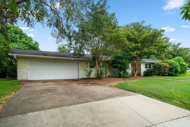 single story home featuring a garage and a front lawn