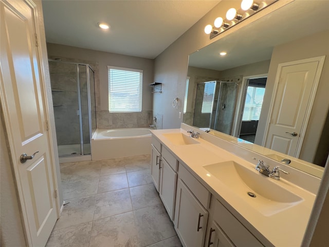 bathroom with plus walk in shower, vanity, and tile patterned floors