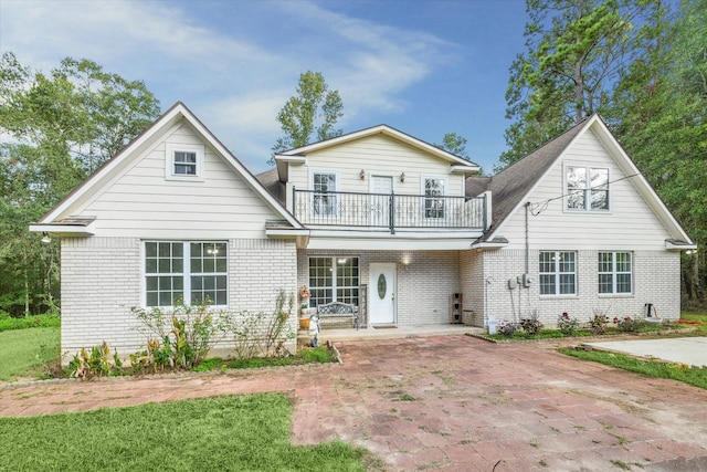 front of property featuring a balcony and a patio area