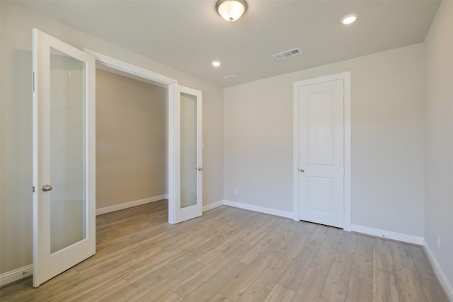 9715 Hunters Run Dr, Missouri City, TX 77459 - unfurnished bedroom featuring french doors, baseboards, visible vents, and light wood finished floors