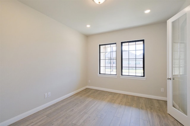 9715 Hunters Run Dr, Missouri City, TX 77459 - spare room featuring recessed lighting, french doors, baseboards, and light wood-style floors