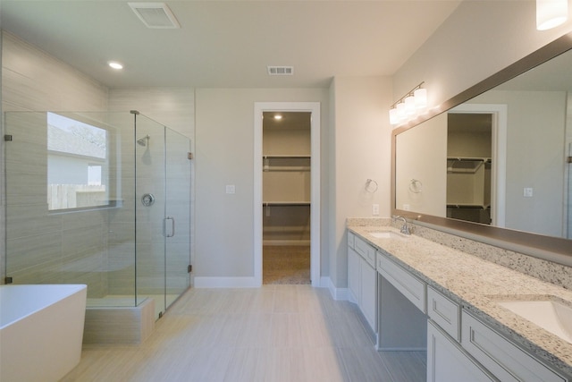 9715 Hunters Run Dr, Missouri City, TX 77459 - bathroom with visible vents, a shower stall, a walk in closet, double vanity, and a sink