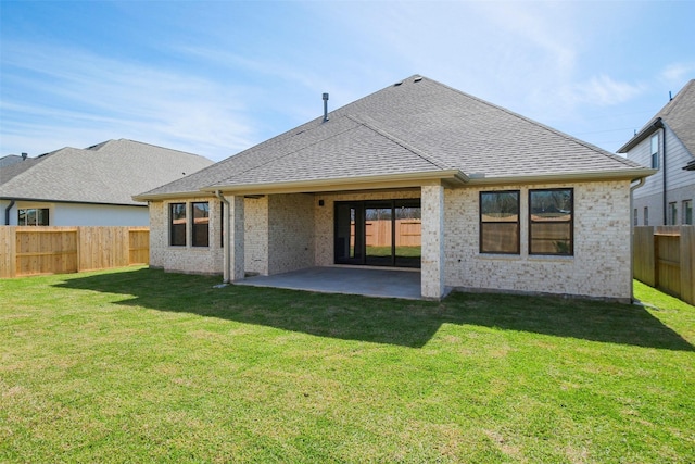 9715 Hunters Run Dr, Missouri City, TX 77459 - back of property with brick siding, roof with shingles, a yard, a fenced backyard, and a patio area