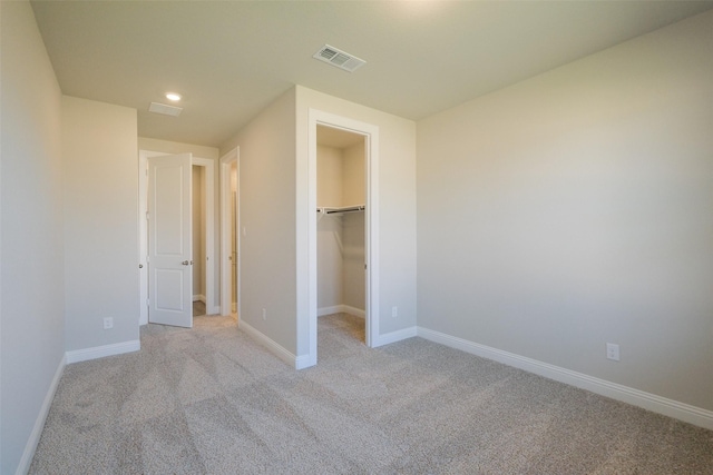 9715 Hunters Run Dr, Missouri City, TX 77459 - unfurnished bedroom with baseboards, visible vents, recessed lighting, a walk in closet, and light colored carpet