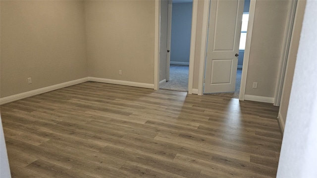 empty room with dark hardwood / wood-style floors