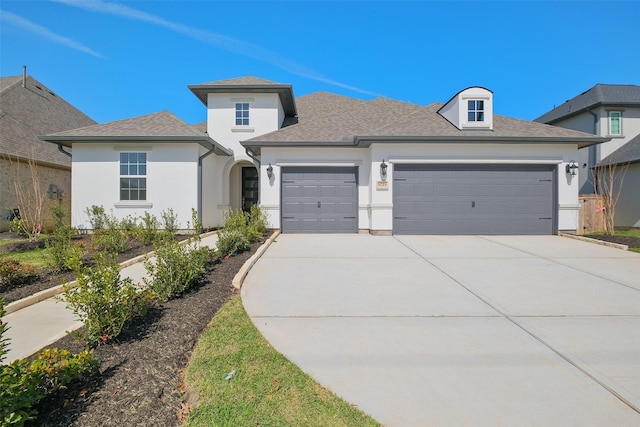 view of front of house featuring stucco siding, roof with shingles, concrete driveway, and an attached garage