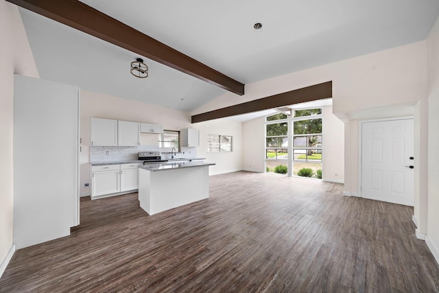 kitchen with dark hardwood / wood-style flooring, tasteful backsplash, lofted ceiling with beams, white cabinets, and stainless steel electric range oven