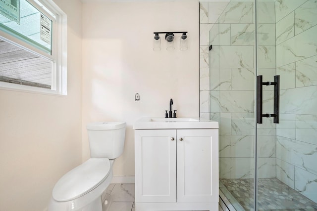 bathroom with vanity, a shower with shower door, and toilet