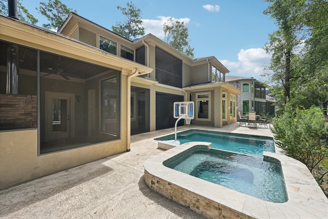 rear view of house with a patio, an in ground hot tub, and ceiling fan