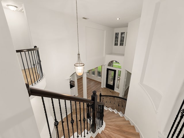 staircase featuring hardwood / wood-style floors and french doors