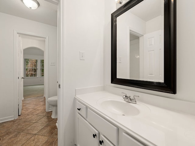 bathroom featuring tile patterned floors, vanity, and toilet