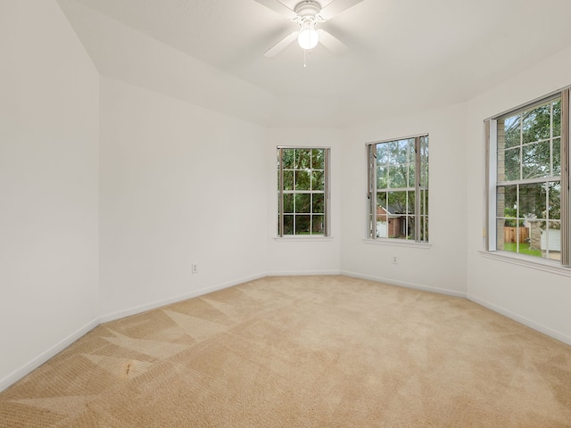 carpeted empty room featuring ceiling fan